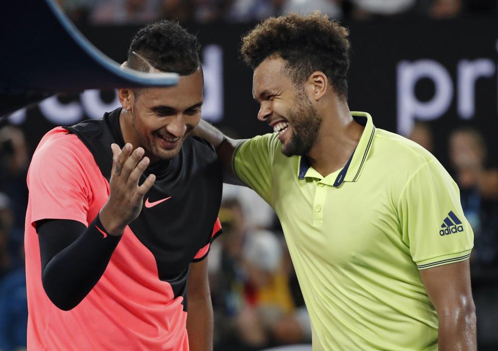 France’s Jo-Wilfried Tsonga (R) congratulates Australia’s Nick Kyrgios after their match at the Australian Open in Melbourne Friday. — AP