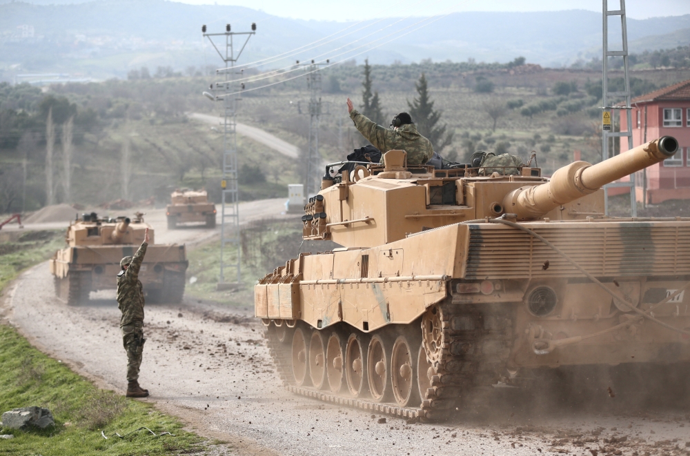 A Turkish military convoy arrives at a village on the Turkish-Syrian border in Kilis province, Turkey, on Sunday. — Reuters