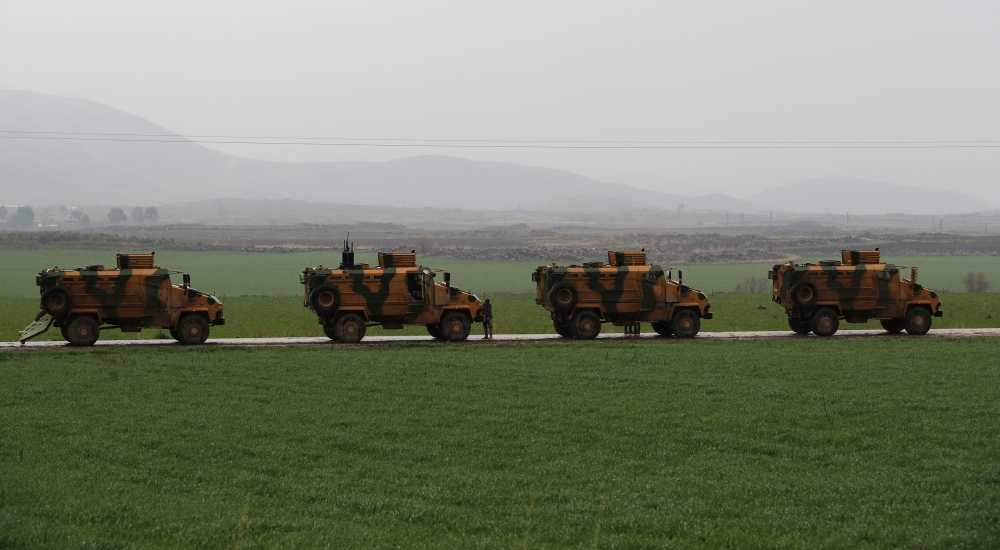 Turkish army vehicles are pictured near the Turkish-Syrian border in Hatay province, Turkey. — Reuters