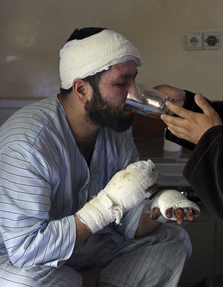 Sayed Mushtaq Hossaini, 26, who was injured in a suicide attack, drinks tea at a hospital in Kabul, Afghanistan. — AP