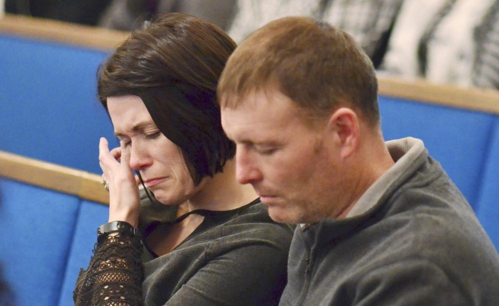 A woman wipes tears from her eye during a prayer vigil at Briensburg Baptist Church near Benton, Ky., Tuesday. — AP