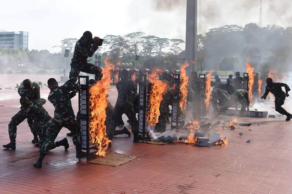 Members of the Indonesian Special Forces display their military skills as US Secretary of Defense Jim Mattis (not pictured) visits the military headquarters in Jakarta, Wednesday. — AFP