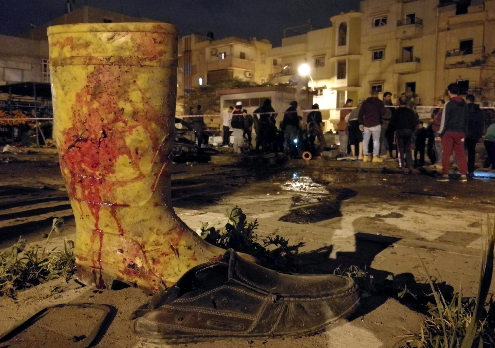 A boot stained with blood is seen at the site of twin car bombs in Benghazi, Libya. — Reuters
