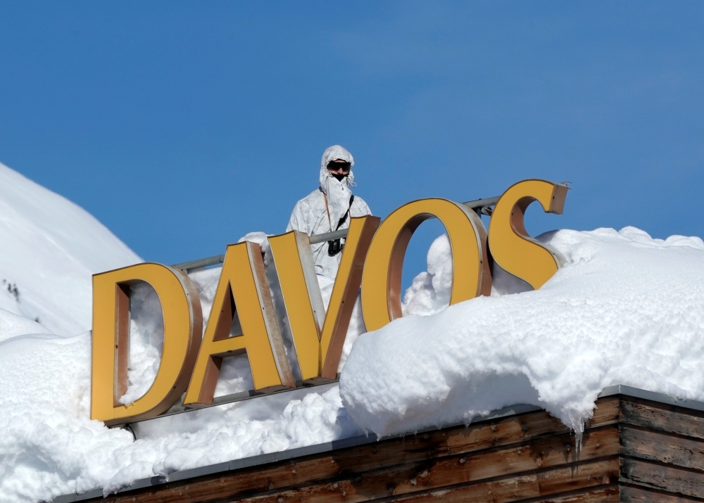 A Swiss special police officer observes the surrounding area from atop the roof of the Davos Congress Hotel during the World Economic Forum (WEF) annual meeting in Davos, Switzerland on Wednesday. — Reuters