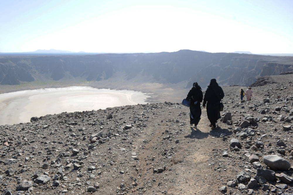 Saudi women walk through the Al-Wahbah volcanic crater in the Al-Wahbah desert, some 360 km northeast of Jeddah in this file photo. — AFP