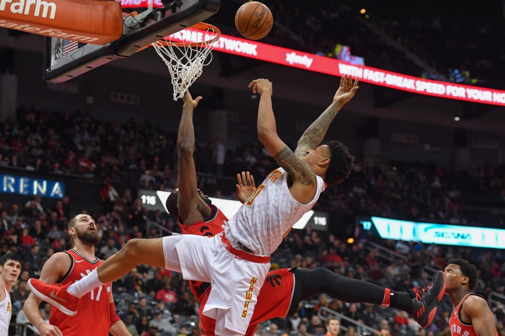 Atlanta Hawks forward John Collins (20) and Toronto Raptors forward Serge Ibaka (9) fight for the ball under the basket during the second half at Philips Arena. — Reuters