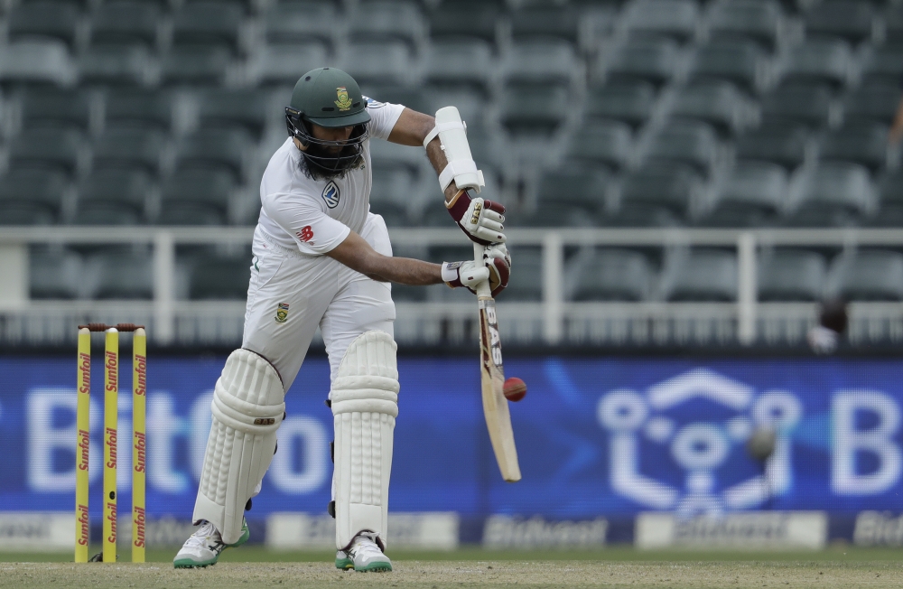 South Africa's batsman Hashim Amla plays a delivery from India's bowler Jasprit Bumrah, and dismissed for 61 runs on the second day of the third cricket Test match between South Africa and India at the Wanderers Stadium in Johannesburg, South Africa, on Thursday. — AP