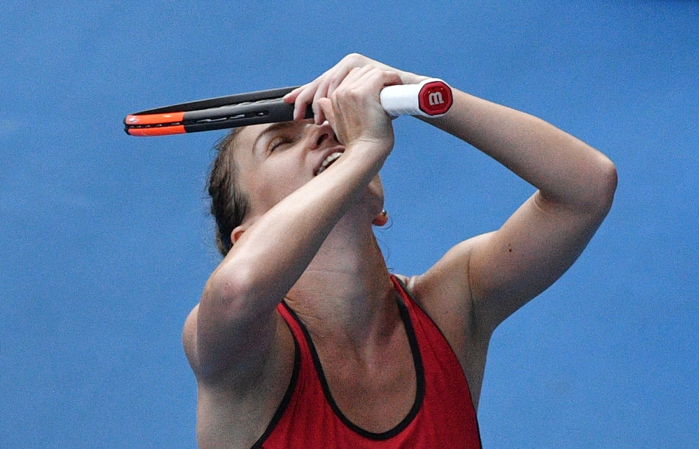 Romania's Simona Halep celebrates beating Germany's Angelique Kerber in their women's singles semifinals match on day 11 of the Australian Open tennis tournament in Melbourne on Thursday. — AFP