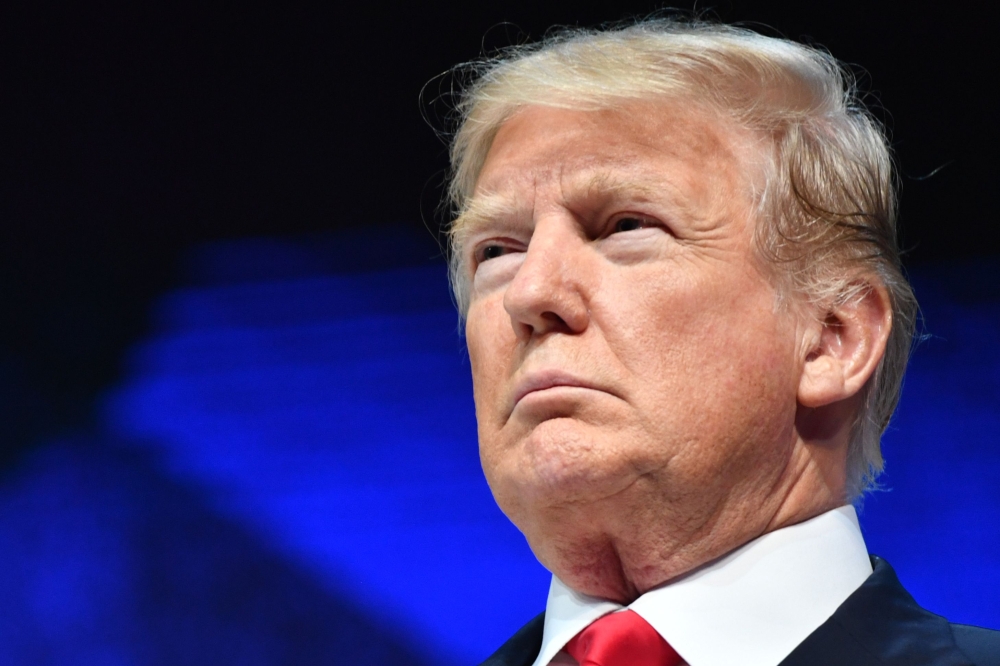 US President Donald Trump looks on before delivering a speech during the World Economic Forum (WEF) annual meeting on Friday in Davos. — AFP