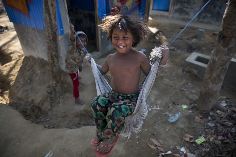 A Rohingya refugee girl swings outside her temporary shelter near Cox's Bazar, Bangladesh. A Bangladesh official says Rohingya refugees are continuing to flee from Myanmar into Bangladesh, even after the two countries said they will begin repatriating members of the minority ethnic group next week. — AP