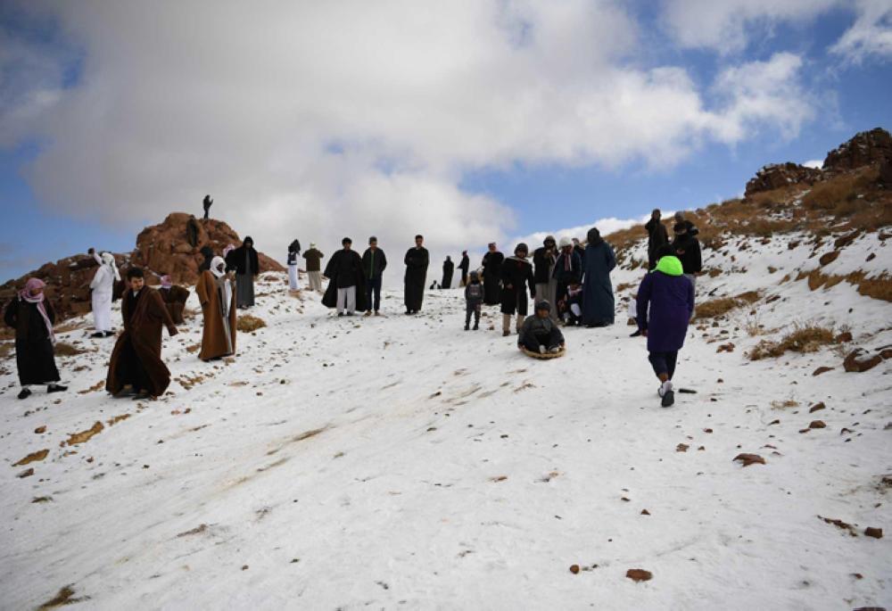 Families enjoy day of sledding as snow drapes Saudi Arabian mountains