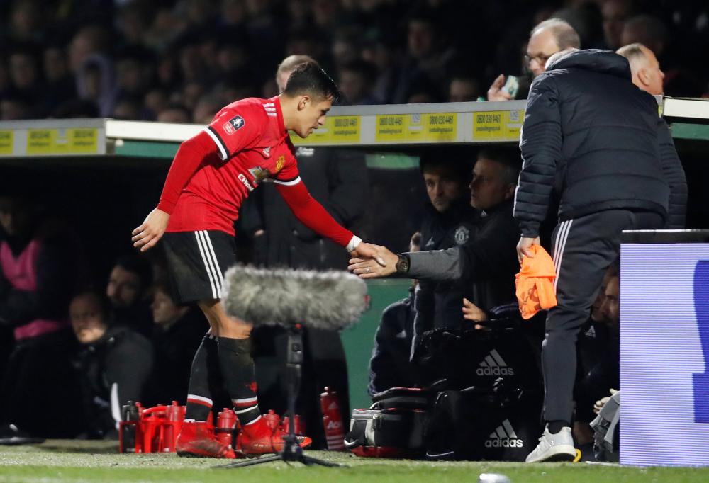 Manchester United’s Alexis Sanchez shakes hands with manager Jose Mourinho after he was substituted during their match against Yeovil Town at Huish Park, Yeovil, Friday. — Reuters