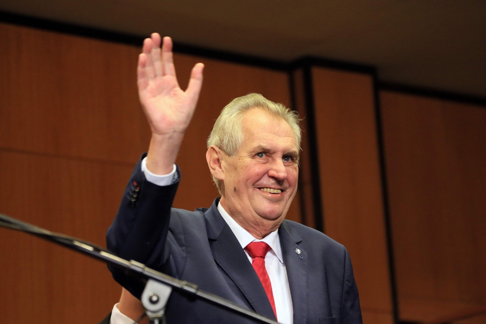 Pro-Russian incumbent Milos Zeman waves as he arrives to celebrate his victory with his staff members after he was reelected Czech President at the Top hotel in Prague on Saturday. — AFP