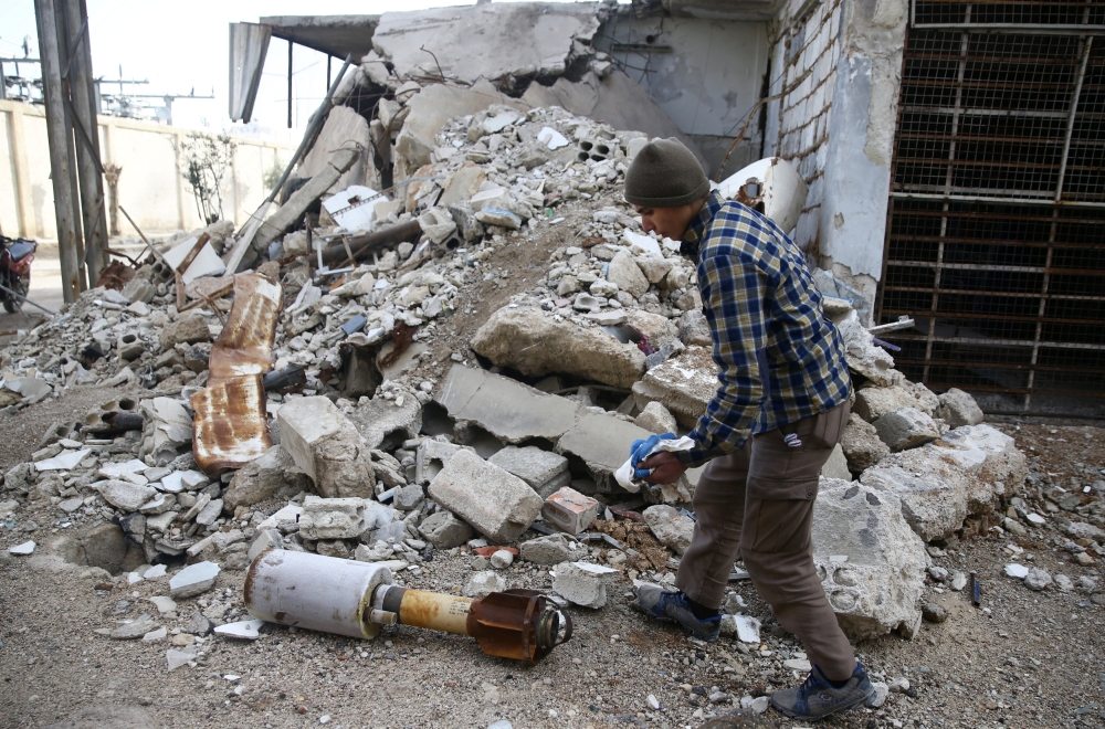 A man is seen near the remains of a rocket in Douma, Eastern Ghouta in Damascus. — Reuters
