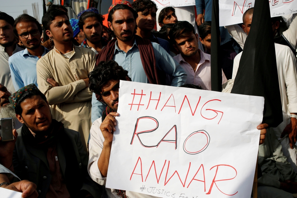 People hold sign as they gather to condemn the death of Naqibullah Mehsud, whose family said was killed by police in a so-called encounter killing, during a grand jirga (tribal assembly or public meeting) in Karachi, Pakistan, in this Jan. 22, 2018 file photo. — Reuters