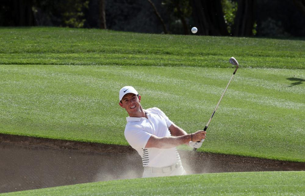 Rory McIlroy of Northern Ireland plays a shot during day three of the Dubai Desert Classic at Emirates Golf Club in Dubai Saturday. — AFP