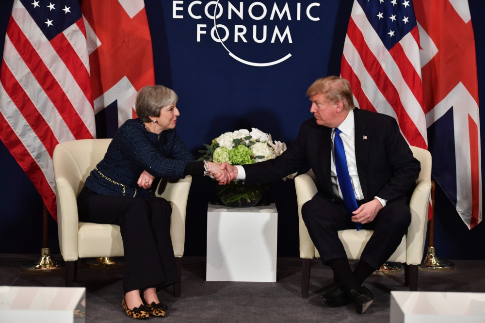 US President Donald Trump and Britain’s Prime Minister Theresa May shake hands during a bilateral meeting on the sidelines of the World Economic Forum (WEF) annual meeting in Davos, eastern Switzerland, on Thursday. — AFP