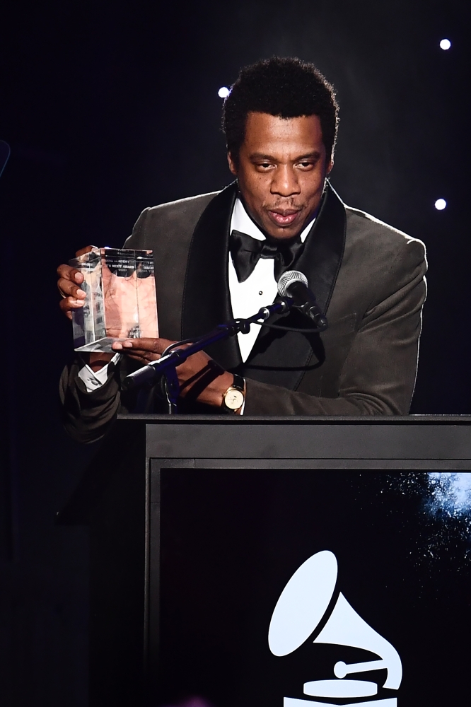 American rapper and businessman, Shawn Corey Carter, known professionally as Jay-Z, acknowledges his Industry Icon award during the traditional Clive Davis party on the eve of the 60th Annual Grammy Awards on Sunday in New York City. - AFP