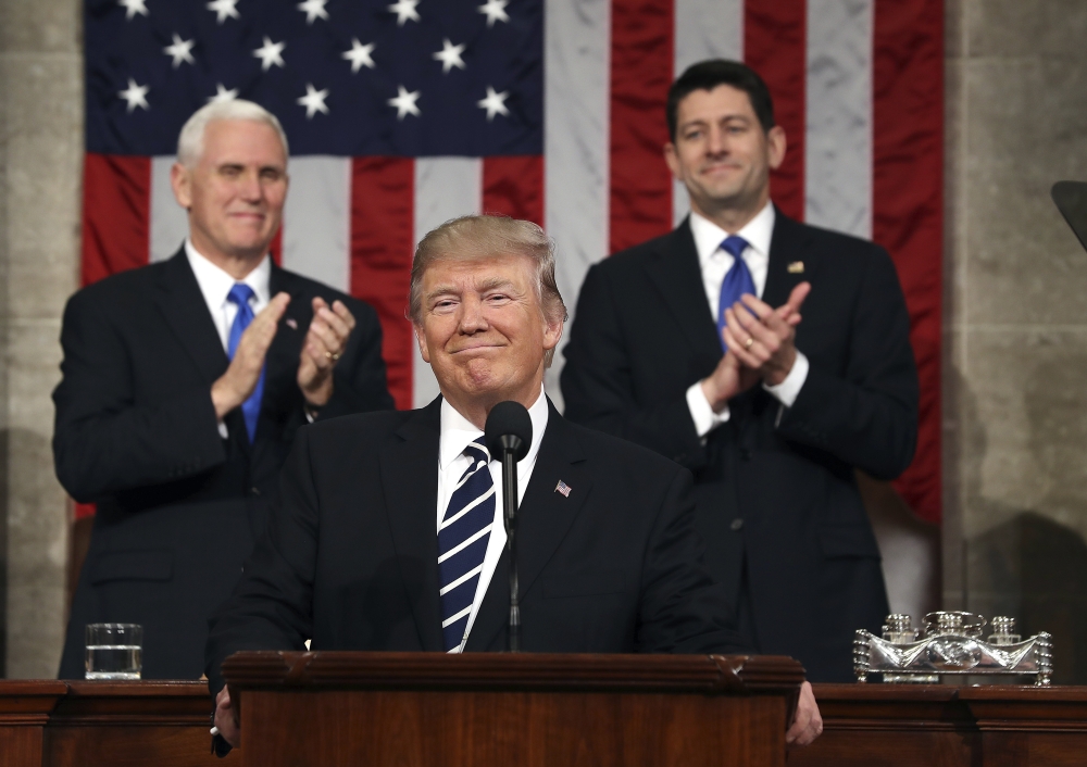 President Donald Trump, flanked by Vice President Mike Pence and House Speaker Paul Ryan of Wis., arrives on Capitol Hill in Washington for his address to a joint session of Congress in this  Feb. 28, 2017 file photo. — AP