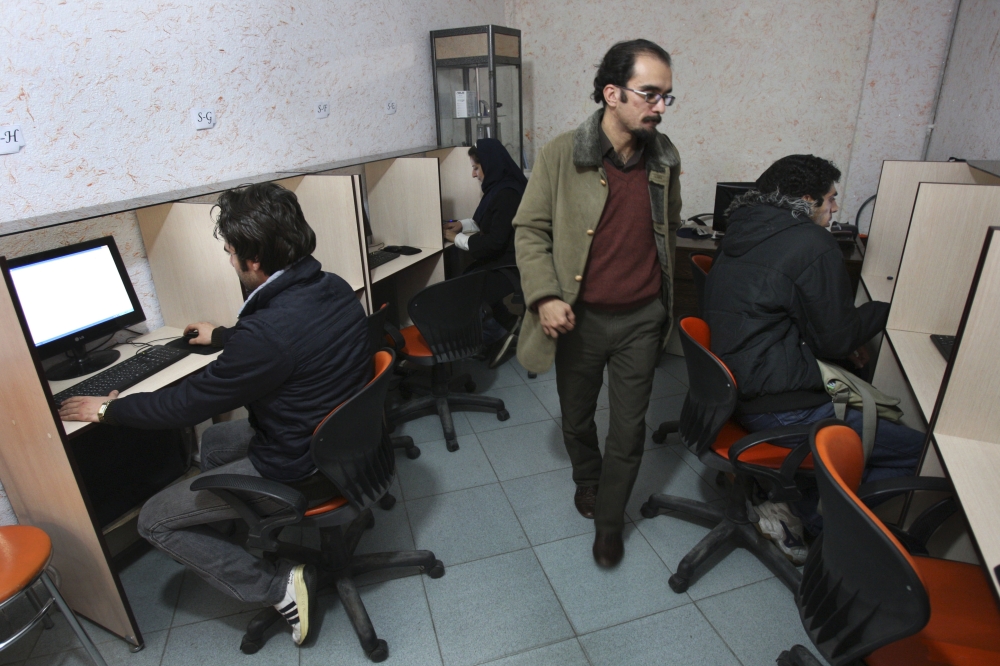 In this Tuesday, Jan. 18, 2011 file photo, Iranians work in an Internet cafe in central Tehran. — AP