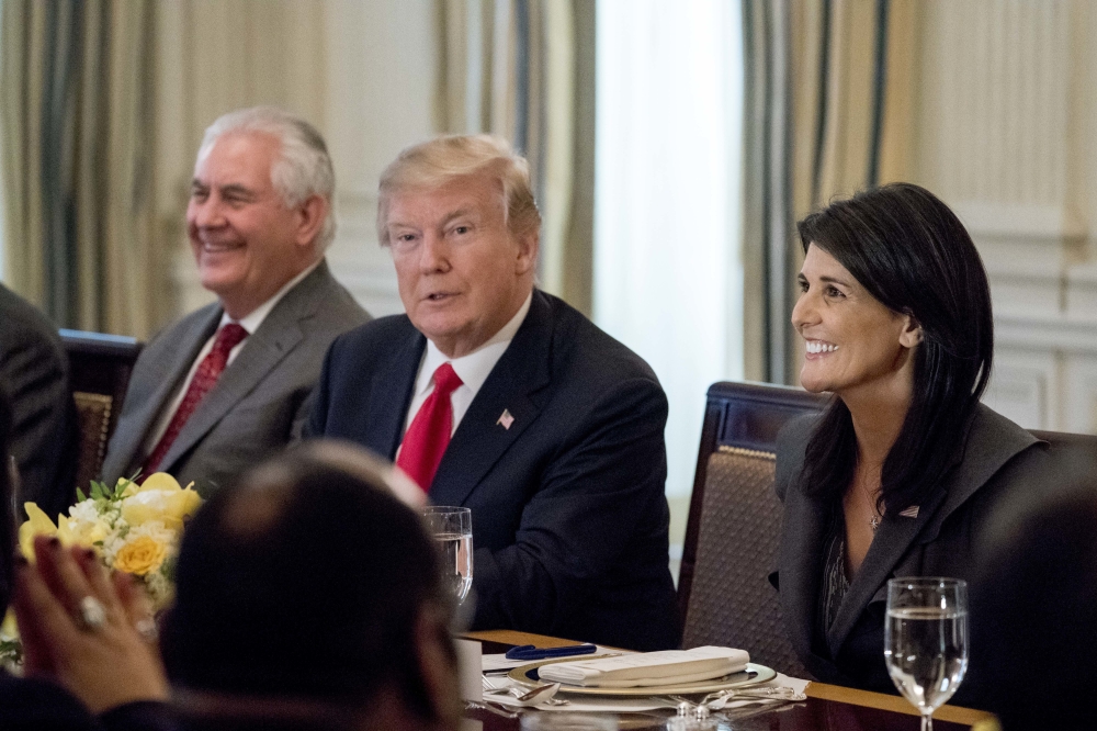 President Donald Trump, accompanied by Secretary of State Rex Tillerson, left, and US Ambassador to the UN Nikki Haley, right, has lunch with the United Nations Security Council in the State Dining Room at the White House, Monday. — AP