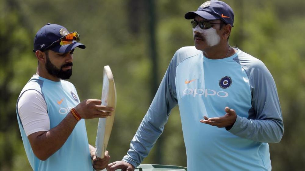 

India skipper Virat Kohli (L) and manager Ravi Shastri talk during a training session before their first One-Day International match in Durban Wednesday. — AP