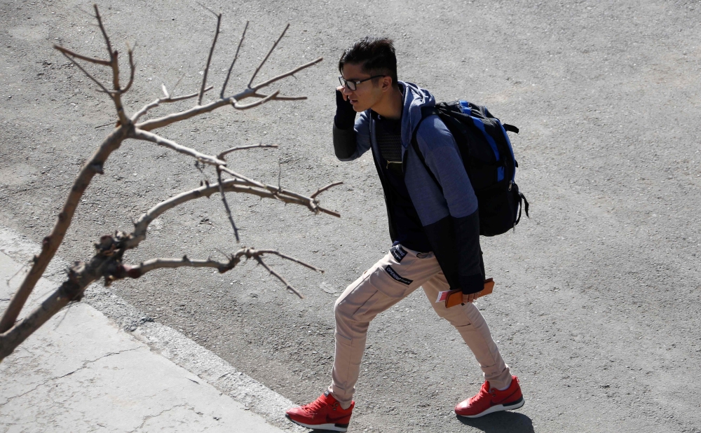 An Iranian traveler arrives at a bus terminal in Tehran, Wednesday. A travel frenzy is gripping young Iranians, who are inspiring each other through social media to overcome traditional constraints and expand their horizons. — AFP