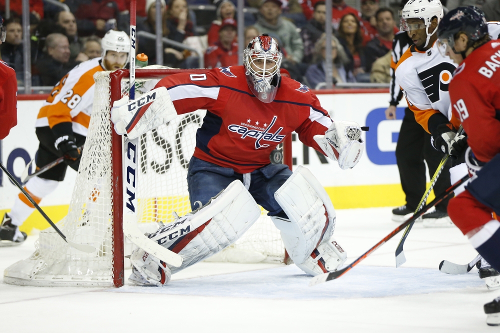 Washington Capitals goaltender Braden Holtby (70) watches the puck in front of Philadelphia Flyers right wing Wayne Simmonds (17) and Capitals center Nicklas Backstrom (19) during the second period at Capital One Arena. — Reuters