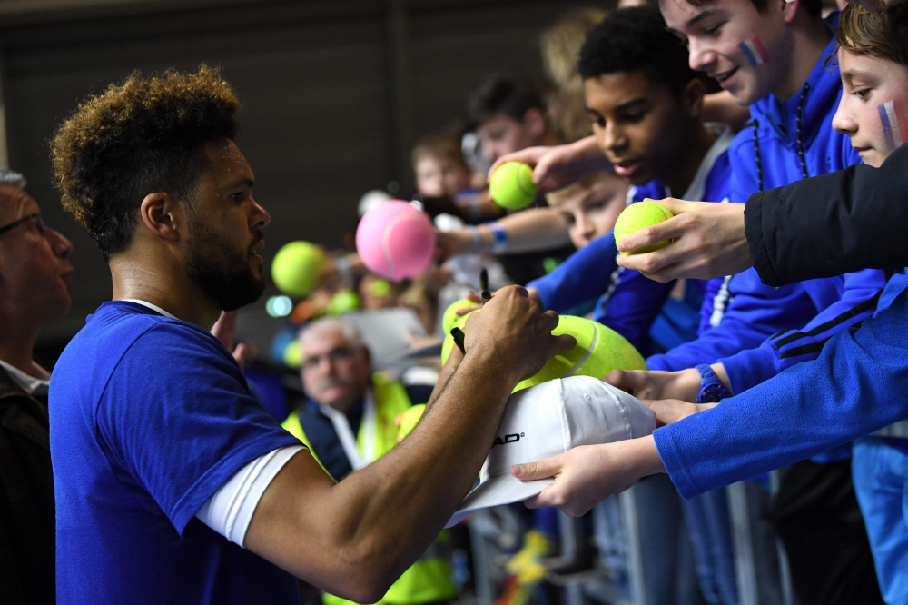 France's Jo-Wilfried Tsonga signs autographs during a training session  ahead of the Davis Cup tennis match between France and the Netherlands at the Halle Olympique Stadium in Albertville on Wednesday. — AFP