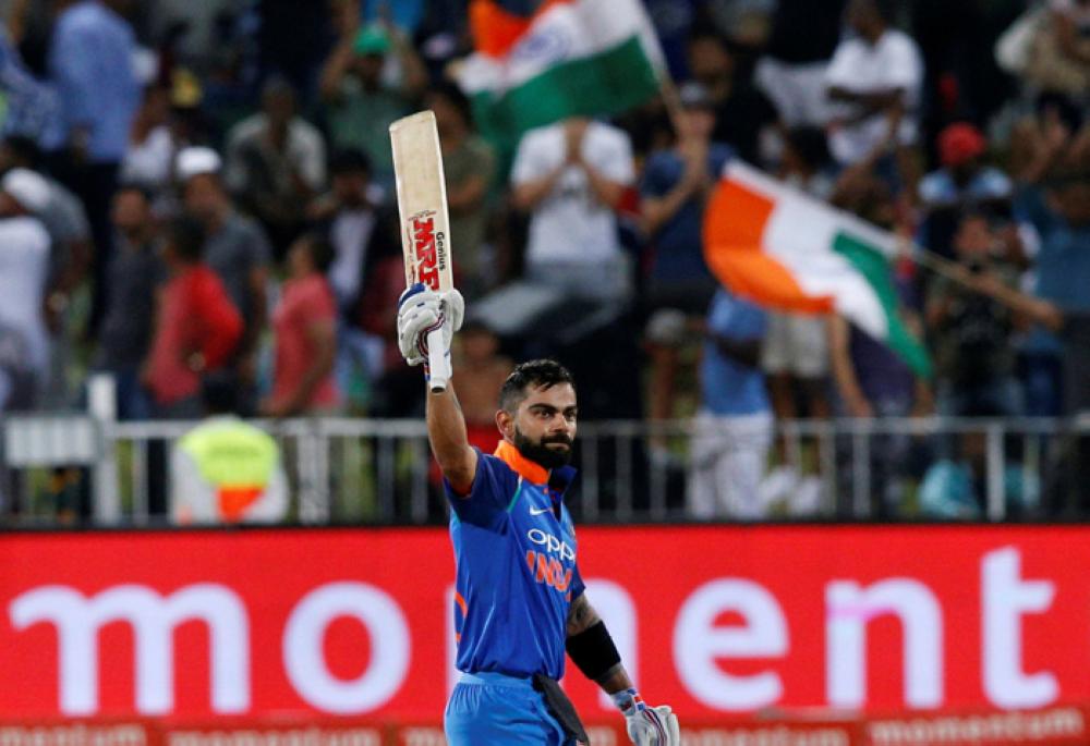India's Virat Kohli celebrates scoring a century. — Reuters
