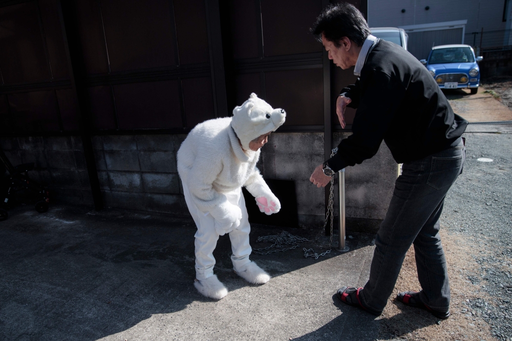 In this picture taken on Jan. 16, Kimiko Nishimoto checks her smartphone at her house in the western Japanese city of Kumamoto. The madcap Japanese great-grandmother armed with a camera and an appetite for mischief has shot to fame for taking side-splitting selfies — many of which appear to put her in harm's way. — AFP photos