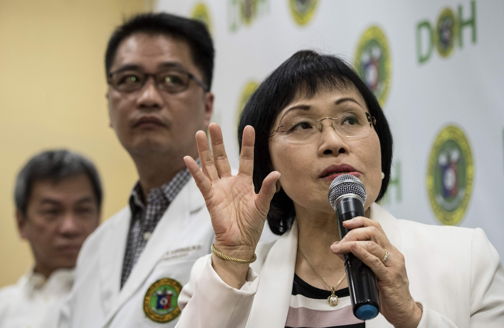 Juliet Sio-Aguilar, right, pediatrician and head of the Philippine General Hospital (PGH) expert panel, speaks during a press conference regarding the Dengvaxia vaccine at the DOH headquarters in Manila on Friday. — AFP