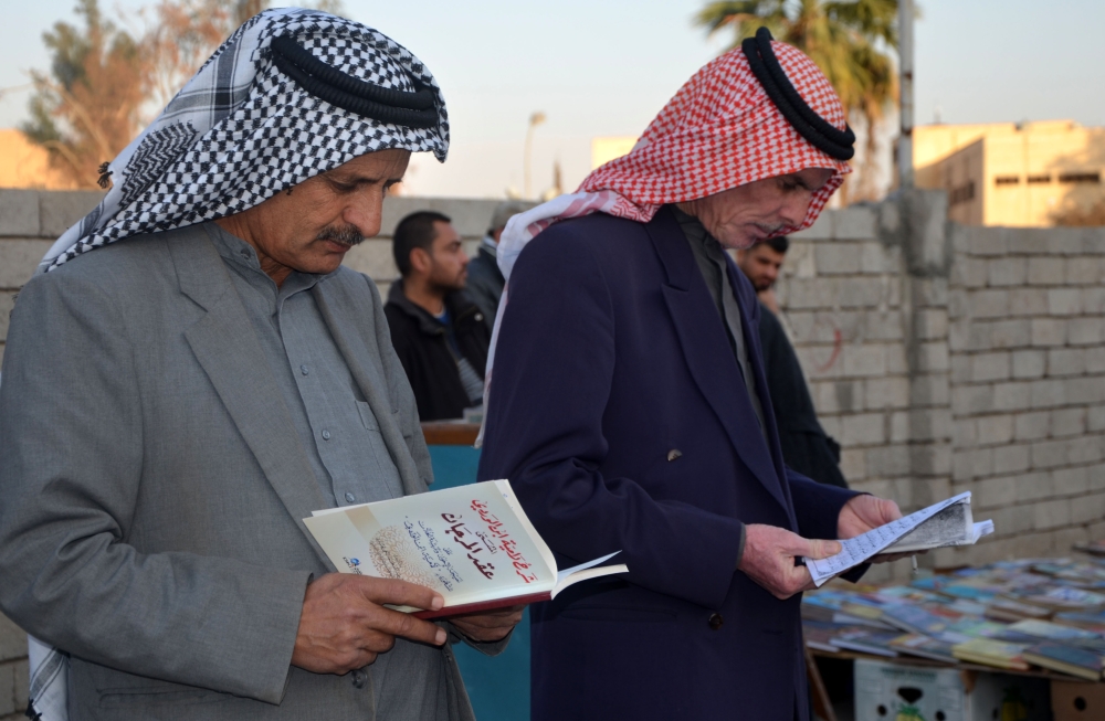 Iraqis gather at a cultural café named 