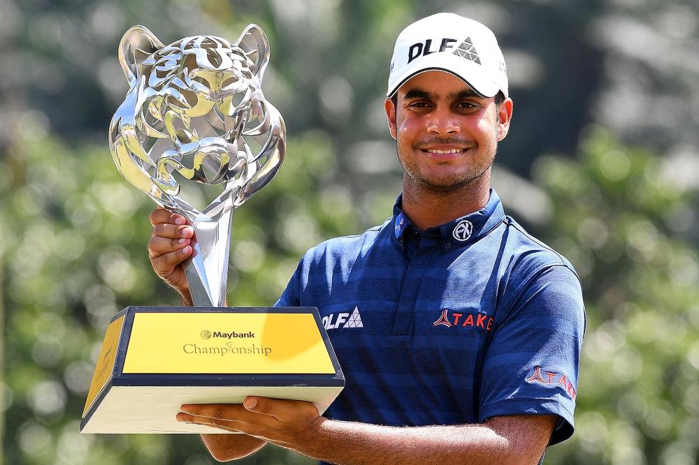 Shubhankar Sharma of India poses with the trophy after winning the 2018 Maybank Malaysia Golf Championship at the Saujana Golf and Country Club outside Kuala Lumpur Sunday. — AFP