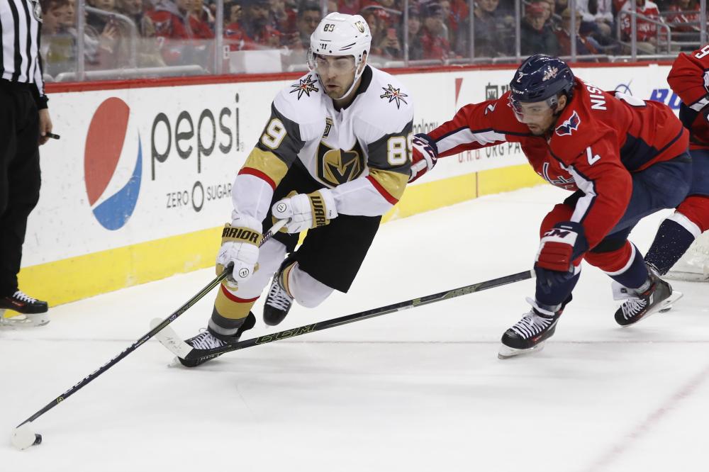 Vegas Golden Knights’ right wing Alex Tuch (L) skates with the puck as Washington Capitals’ defenseman Matt Niskanen chases during their NHL game at Capital One Arena in Washington Sunday. — Reuters