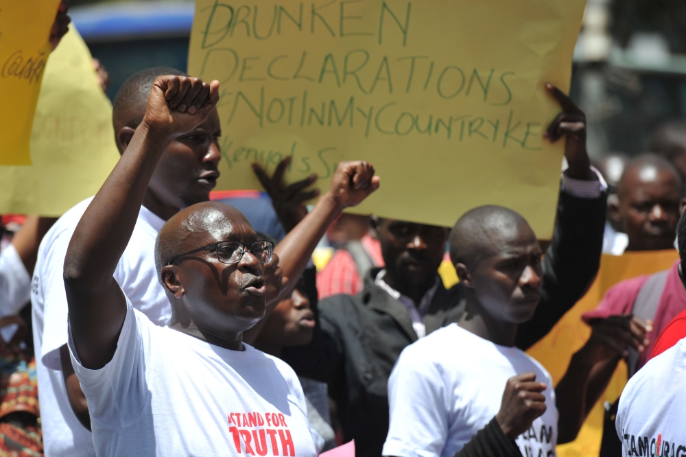 Civil rights activists demonstrate on Monday in the streets of Nairobi to protest against the shutdown of three major TV channels to stop them from broadcasting  a “swearing-in” of opposition leader on Jan. 30. — AFP