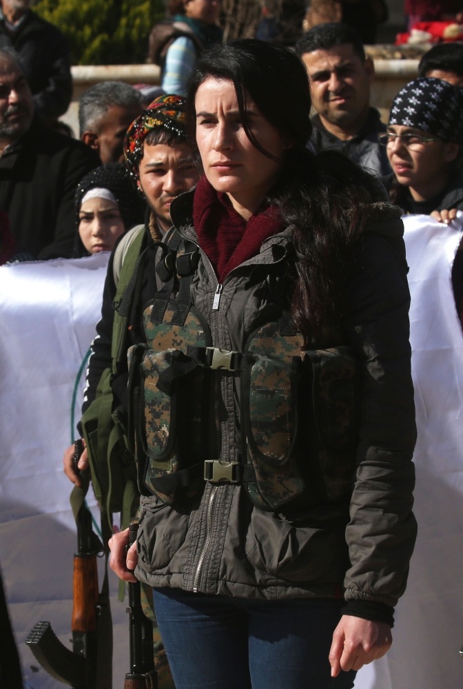 Syrian-Kurds attend an impromptu parade in Afrin as civilians enlist to fight an assault by Turkish troops and allied rebels on the Kurdish People's Protection Units (YPG) in Syria's border region. — AFP