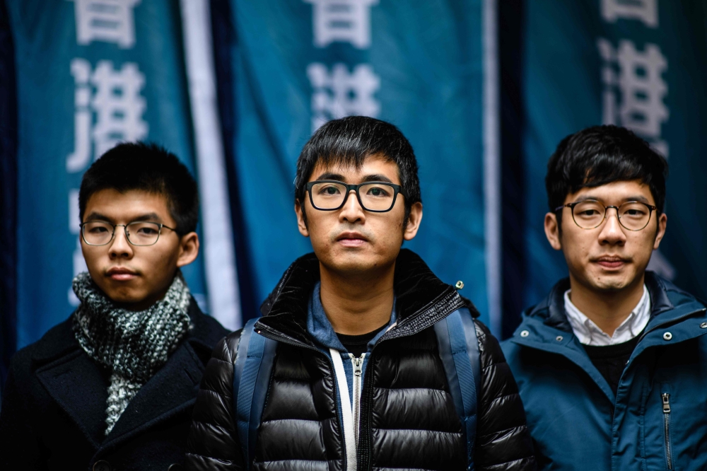 Hong Kong’s leading democracy activists (left to right) Joshua Wong, Nathan Law and Alex Chow arrive outside the Court of Final Appeal in Hong Kong on Tuesday. — AFP