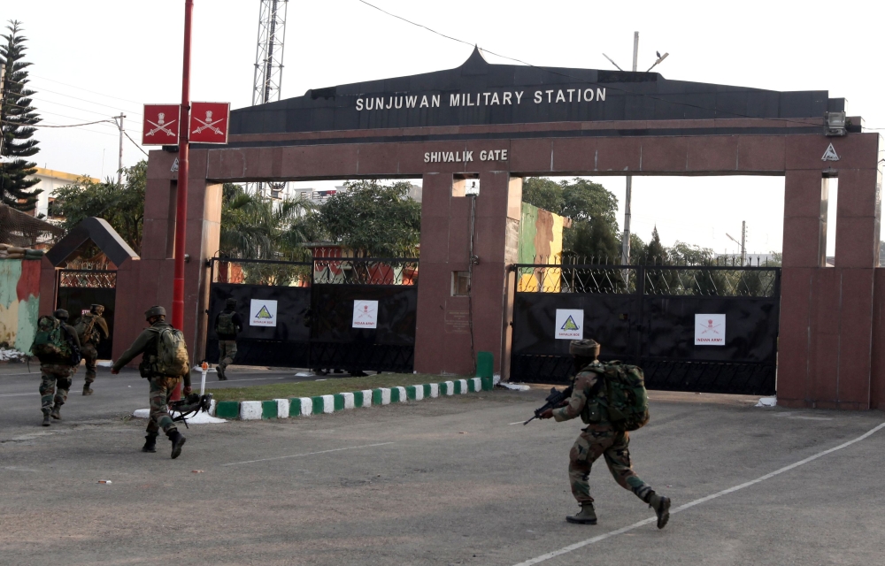 Indian soldiers enter the Sunjuwan Military Station in Jammu on Saturday following an attack by militants. — AFP