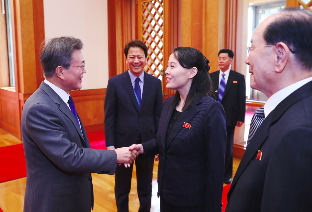South Korean President Moon Jae-in, left, greets North Korean leader Kim Jong Un’s sister Kim Yo Jong, center, as North Korea’s ceremonial head of state Kim Yong Nam, right, looks on before their meeting at the presidential Blue House in Seoul on Saturday. — AFP