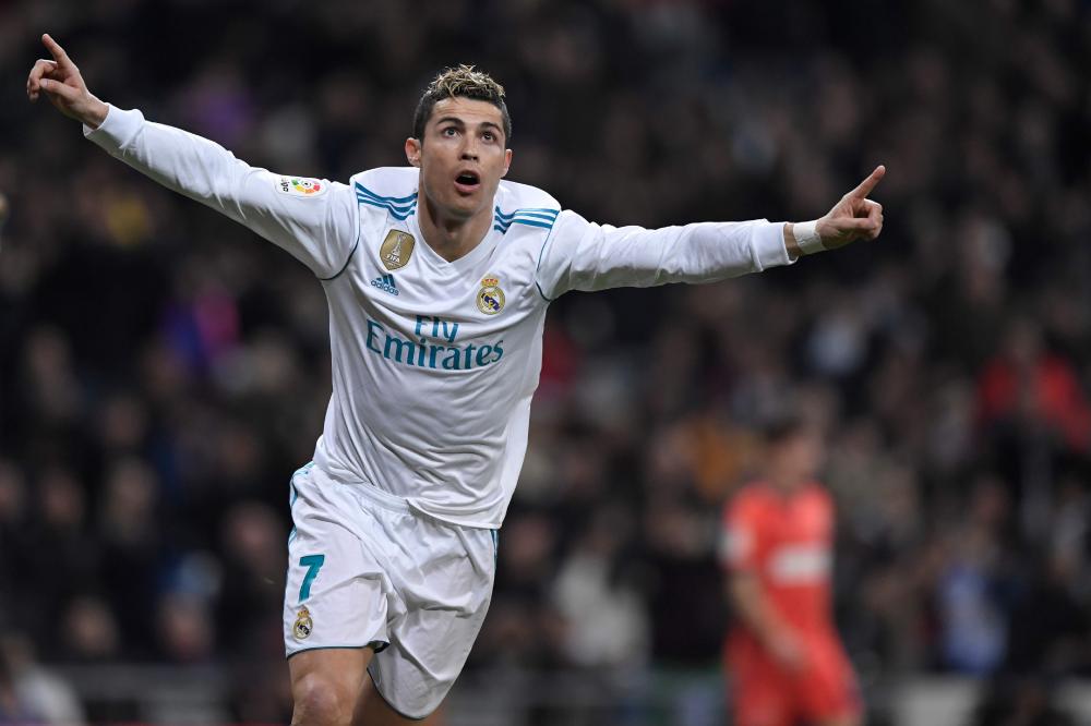 Real Madrid’s Cristiano Ronaldo celebrates after scoring during their Spanish league football match against Real Sociedad at the Santiago Bernabeu Stadium in Madrid Saturday. — AFP