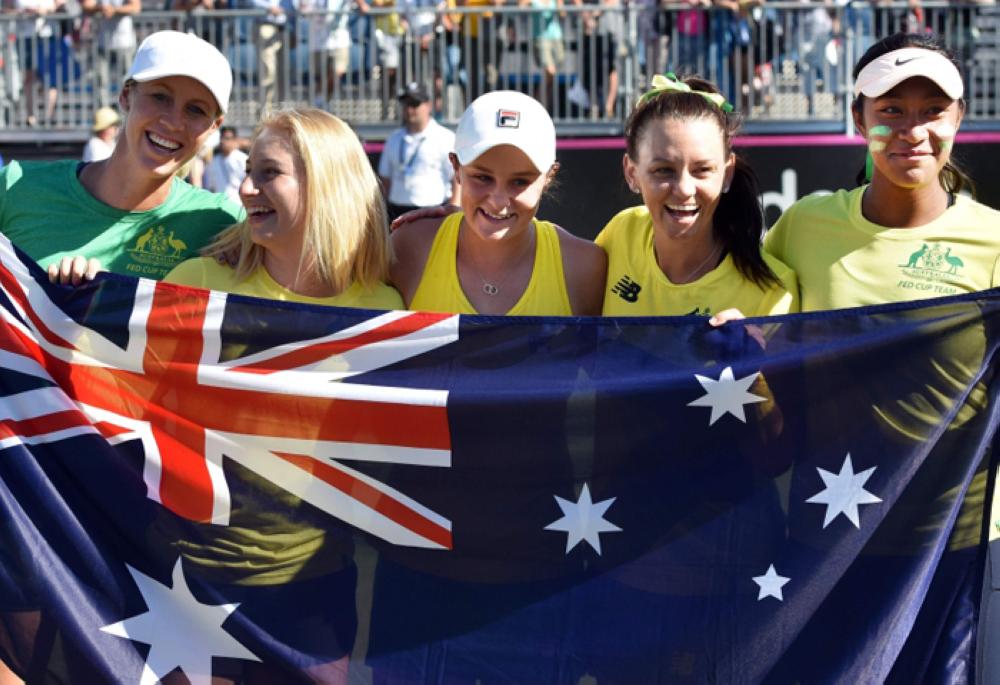 (L to R) Australia’s captain Alicia Molik poses with players Daria Gavrilova, Ashleigh Barty, Casey Dellacqua and Destanee Aiava as they celebrate their win over Ukraine in the Federation Cup tennis match in Canberra Sunday. — AFP