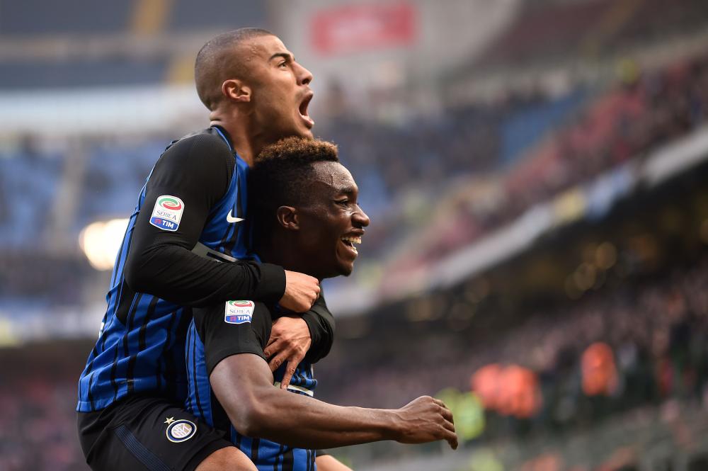 Inter Milan's forward Yann Karamoh (R) celebrates with teammate Brazilian midfielder Rafinha Alcantara after scoring during their Italian Serie A football match against Bologna at the San Siro Stadium in Milan Sunday. — AFP