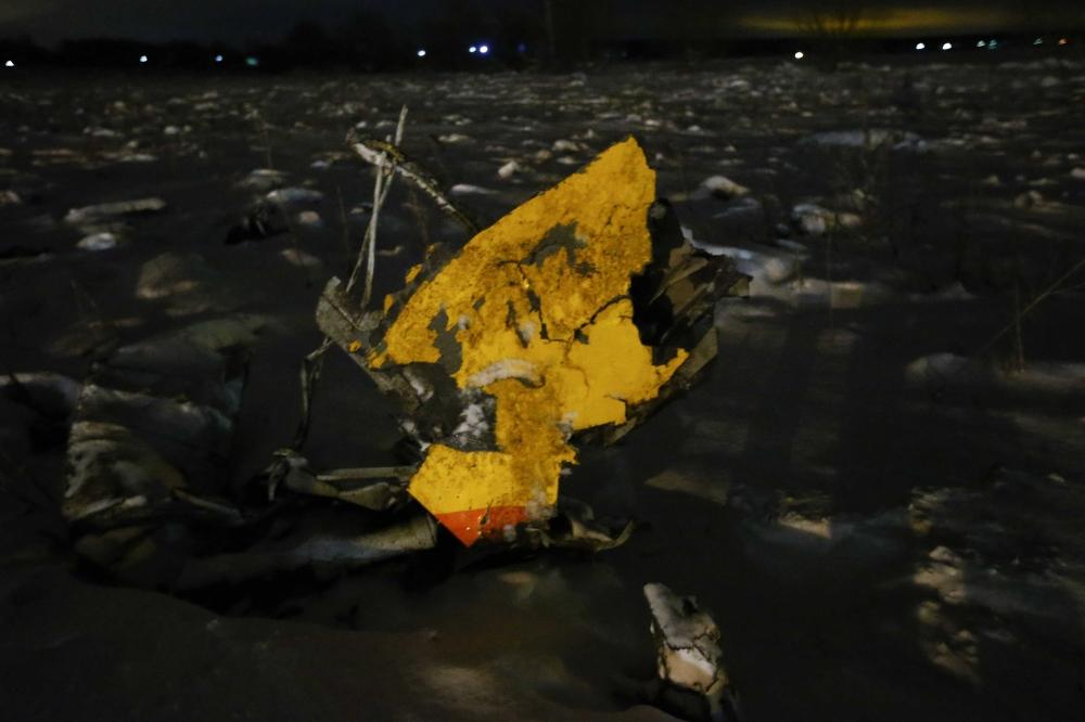 A part of a Saratov Airlines Antonov AN-148 plane that crashed after taking off from Moscow's Domodedovo airport is seen at the scene of the incident outside Moscow on Sunday. -- Reuters