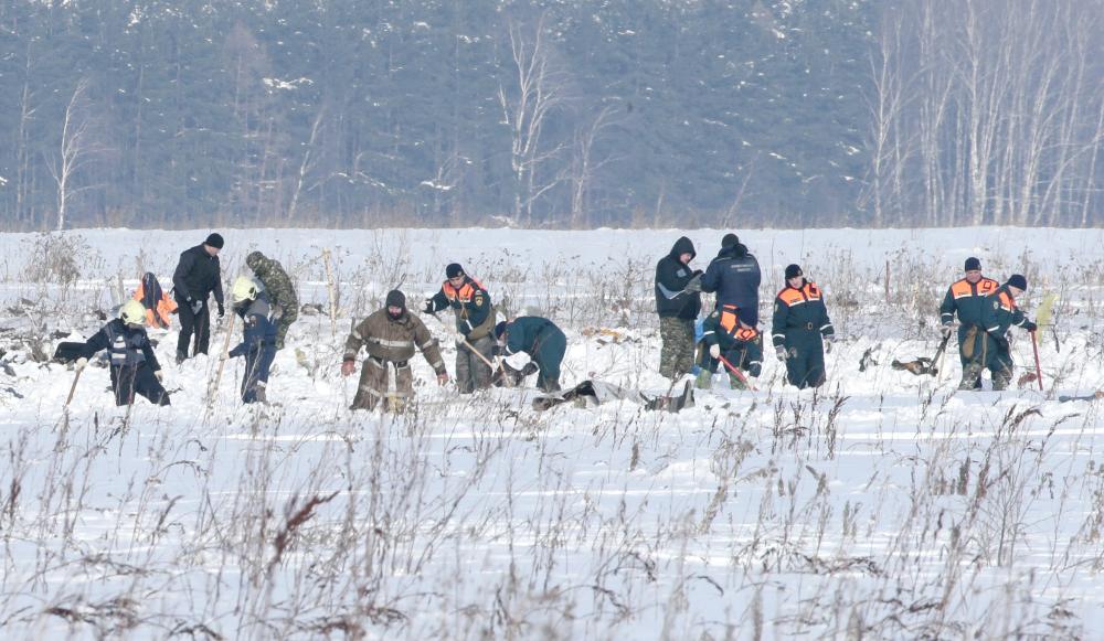 Russian Emergency Situations Ministry members work at the crash site of the short-haul AN-148 airplane operated by Saratov Airlines in Moscow region, Russia, on Monday. — Reuters