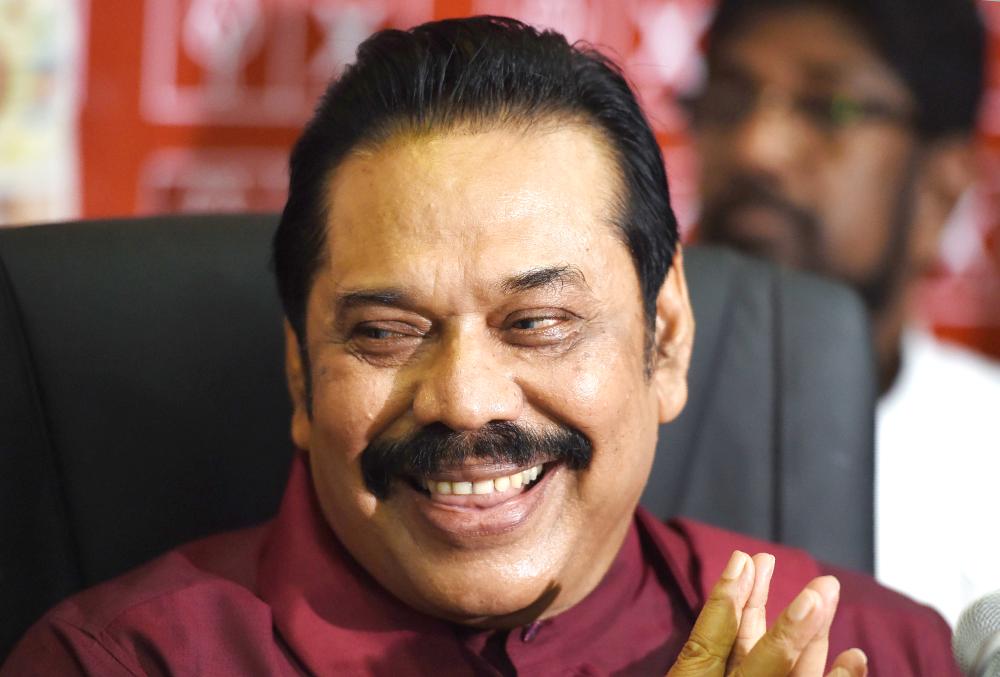 Former Sri Lankan President Mahinda Rajapaksa takes part in a press conference in Colombo on  Monday. — AFP