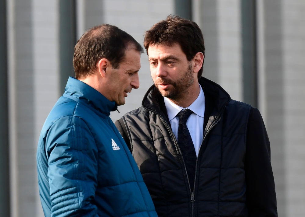 Juventus' Italian coach Massimiliano Allegri (L) talks with Juventus's President Andrea Agnelli during the Media Day in Vinovo, near Turin, on Monday, on the eve of the UEFA Champions League round of 16 football match against Tottenham. — AFP