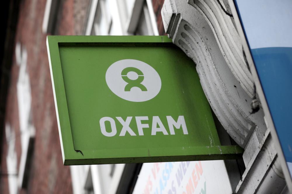 A sign is seen above a branch of Oxfam, in central London, Britain, on Tuesday. — Reuters