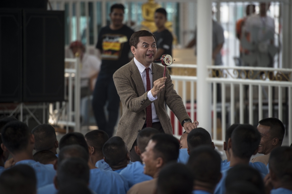 Mongkol Preechajan, 43, performs in front of prison inmates as the popular British TV comedy character Mr. Bean, in the central Thai province of Nakhon Nayok. - AFP