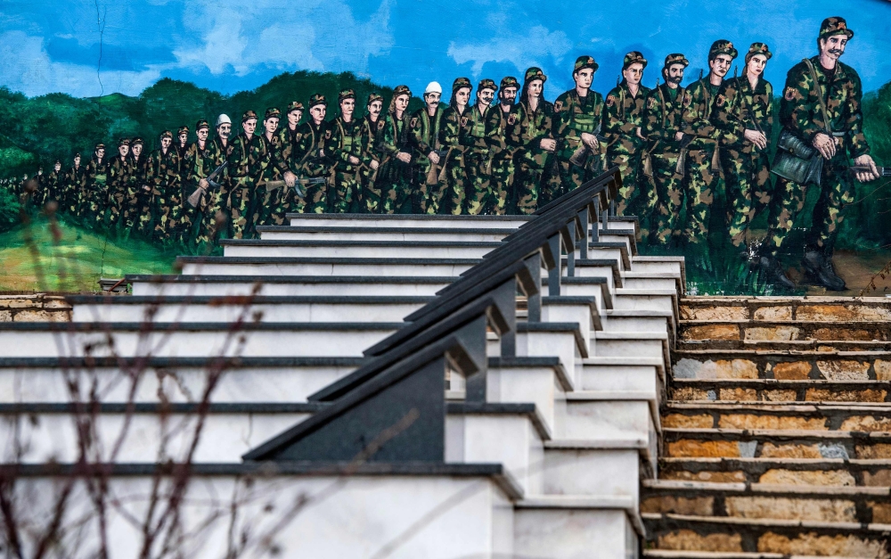 Graffiti featuring the Kosovo Liberation Army soldiers at a martyrs cemetery in the village of Stagova near the town of Kacanik. Former Kosovo pro-independence rebels do not want to drop their pedestal: they reject the new international court which is soon expected to announce first indictments for war crimes. — AFP photos